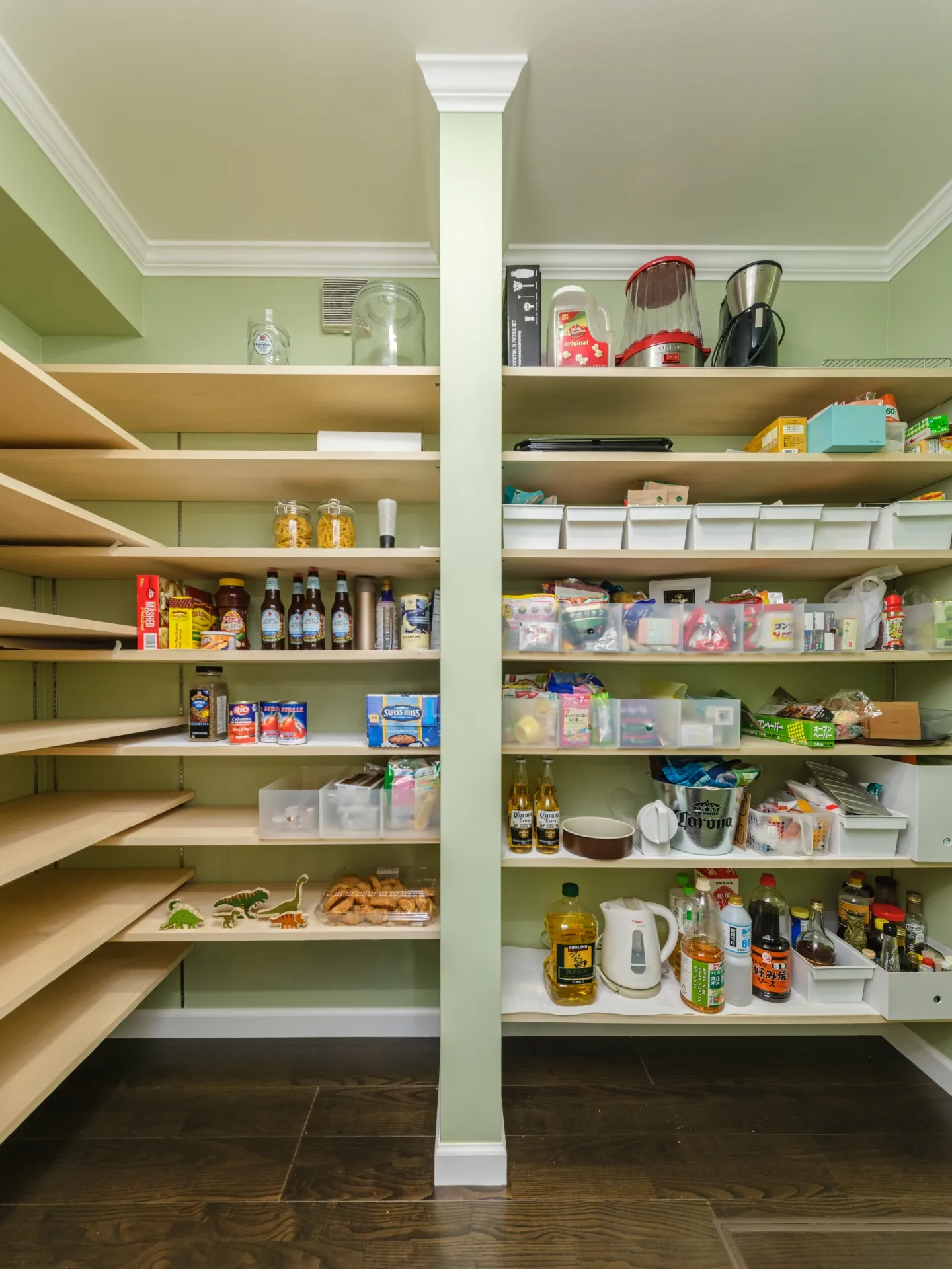 淡いグリーンの壁とシンプルな棚板で、機能性とデザイン性を兼ね備えたパントリー。 内部はキッチンと同等の広さがあるため、食料品や生活用品のストックをたっぷり収納できます。